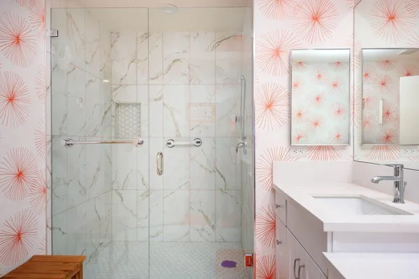 a bathroom with a sink vanity granite shower and a mirror