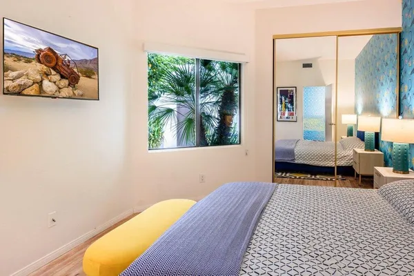 a bedroom with a bed and a painting on the wall