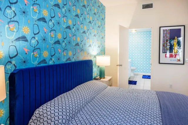 a patio with a table and chairs and potted plants