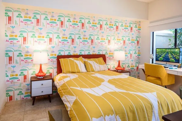 a bedroom with 2 bed and a couch