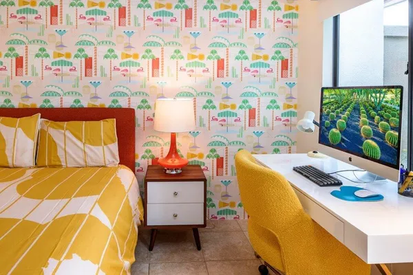 a bedroom with a bed and a desk