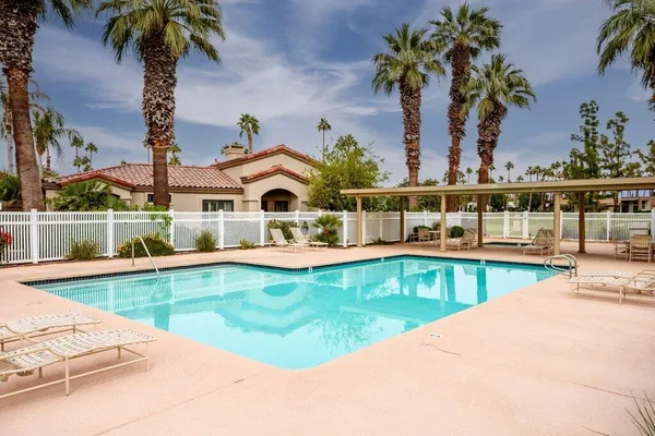 swimming pool view with a outdoor seating