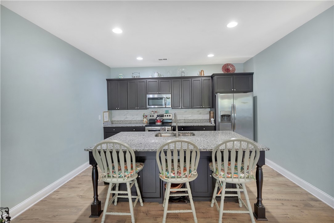 121 Ventura Street Anderson, SC 29621 - Photo 8 of 32 A well-appointed kitchen showcasing a spacious island with bar seating and integrated sink.