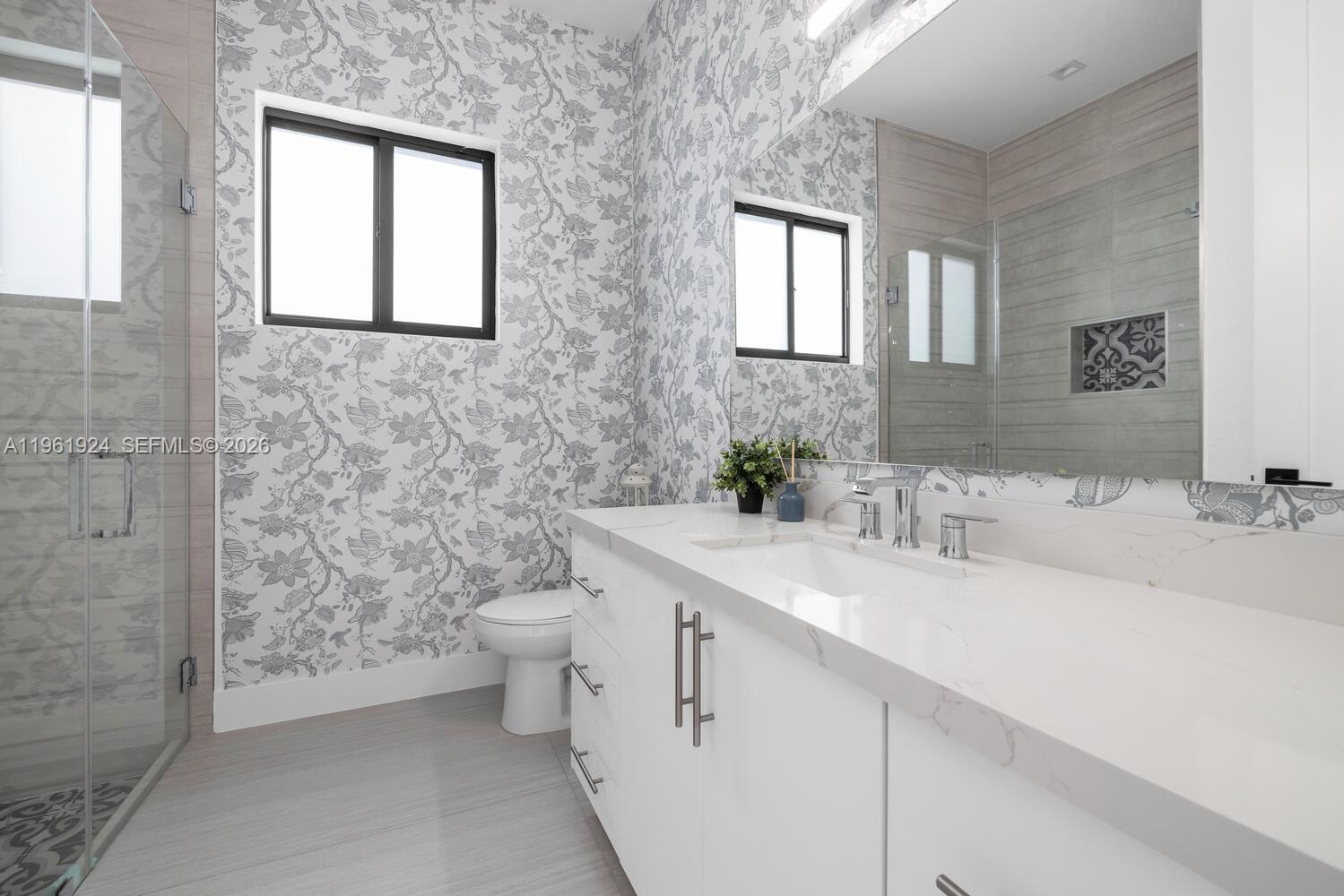 14468 Southwest 16th Street Miami, FL 33175 - Photo 11 of 46 a bathroom with a double vanity sink toilet and a mirror