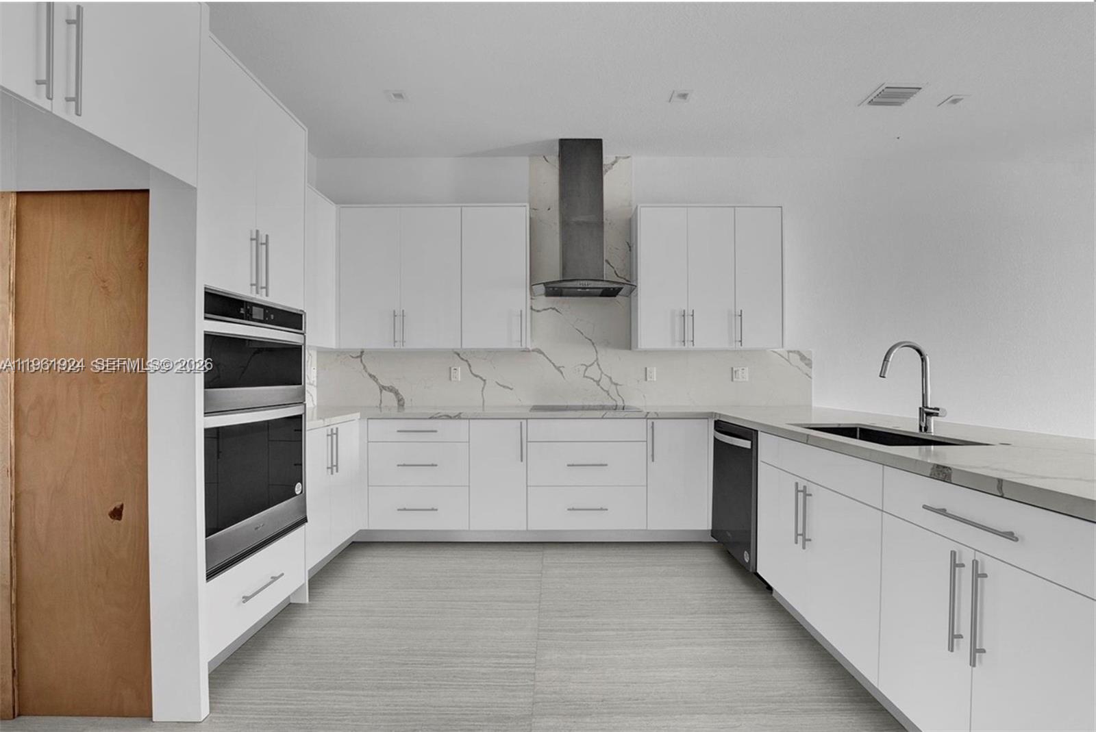 14468 Southwest 16th Street Miami, FL 33175 - Photo 12 of 46 a kitchen with granite countertop white cabinets and stainless steel appliances