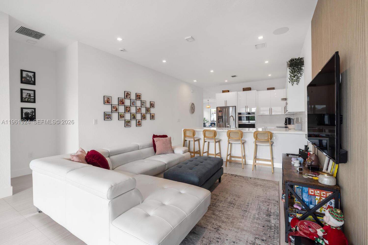 14468 Southwest 16th Street Miami, FL 33175 - Photo 13 of 46 a living room with furniture and a flat screen tv