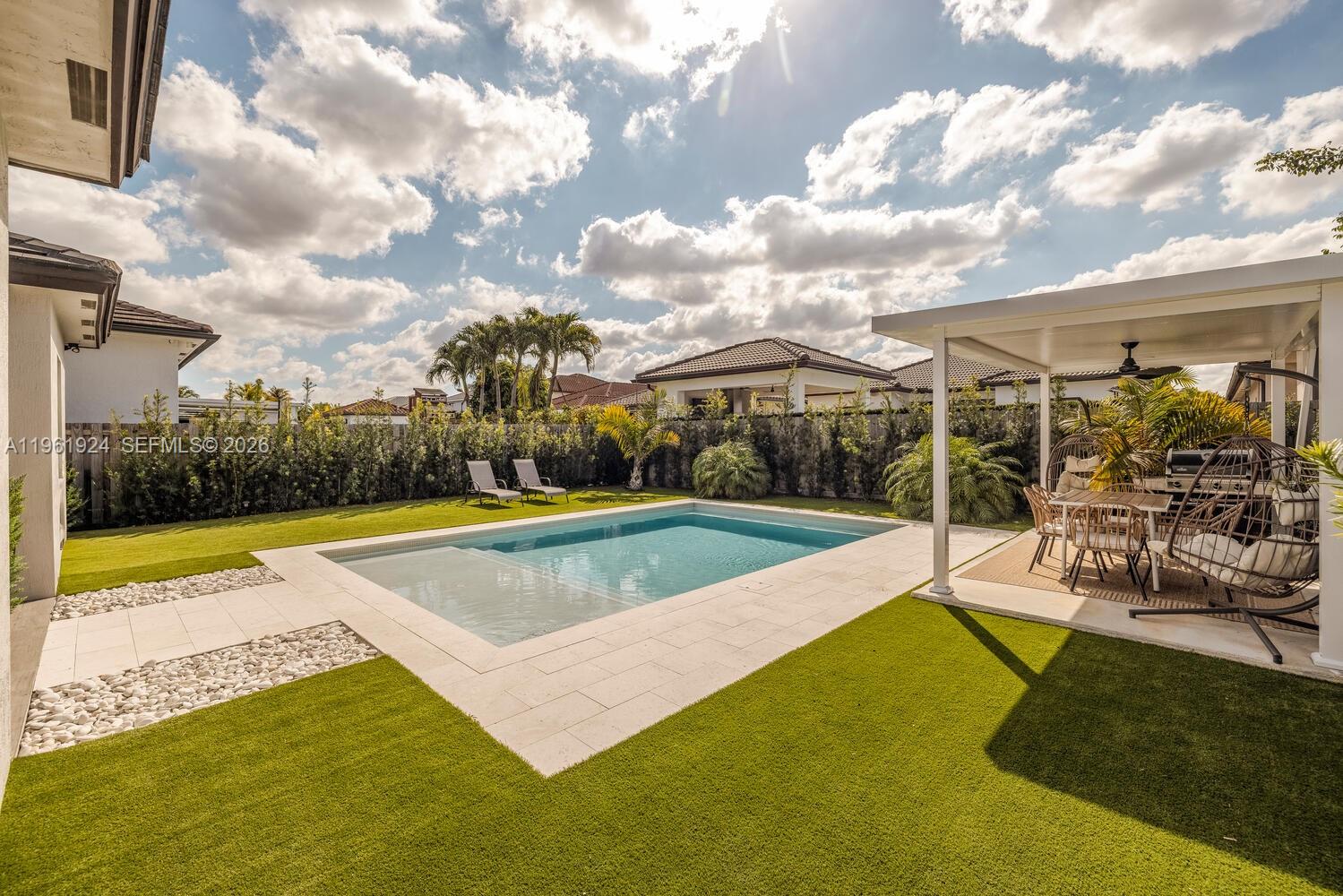 14468 Southwest 16th Street Miami, FL 33175 - Photo 19 of 46 a view of a house with swimming pool and sitting area