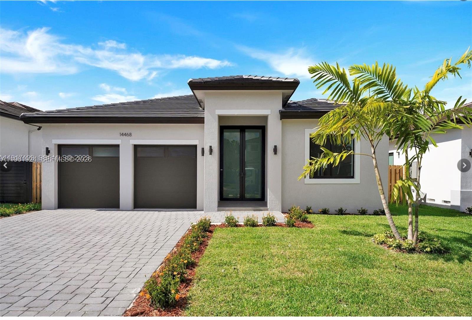 14468 Southwest 16th Street Miami, FL 33175 - Photo 2 of 46 a front view of a house with a yard