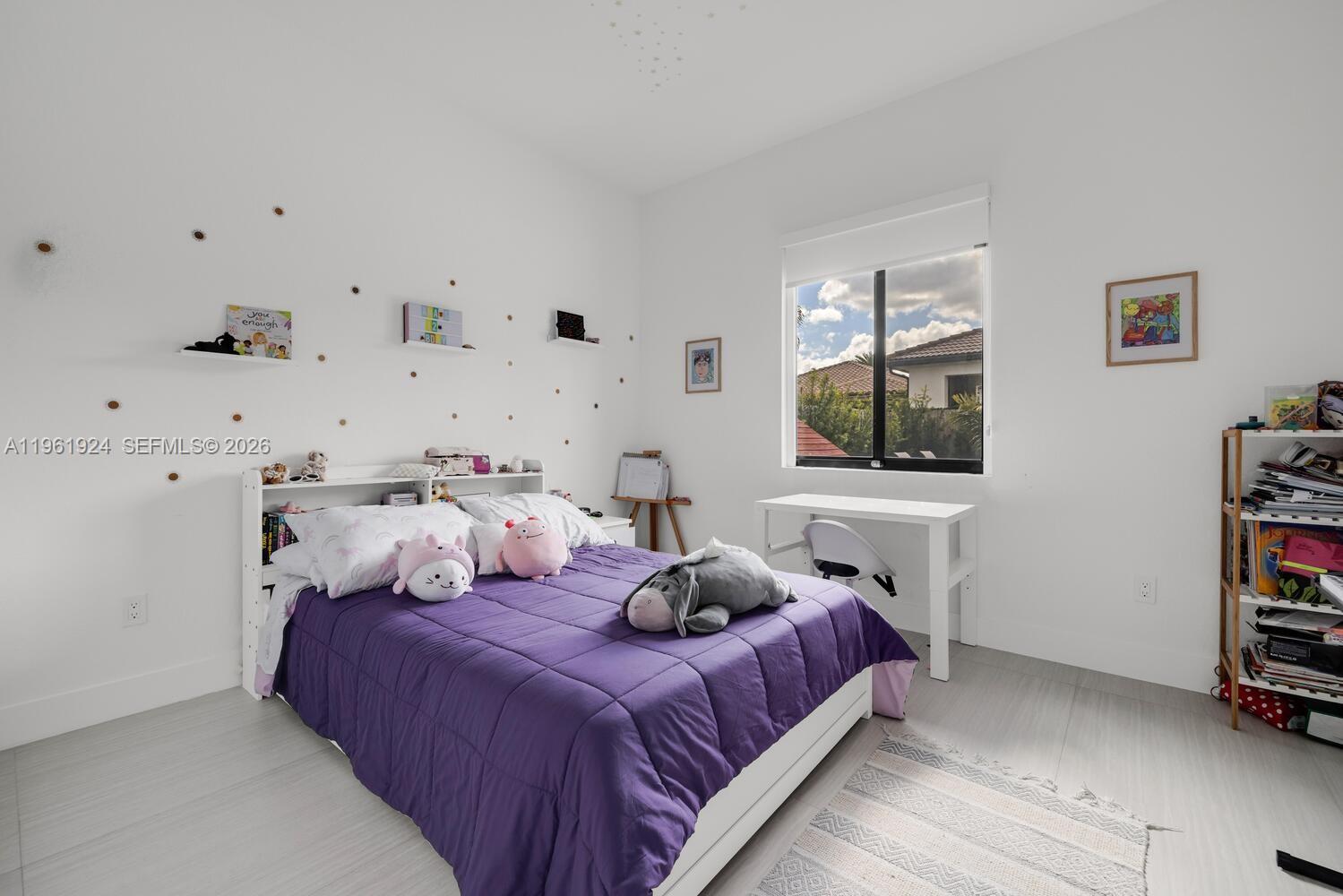 14468 Southwest 16th Street Miami, FL 33175 - Photo 22 of 46 a bedroom with bed and a flat tv screen on the dresser