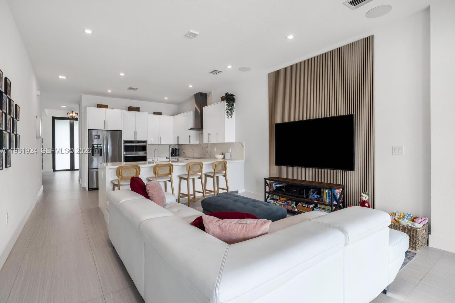 14468 Southwest 16th Street Miami, FL 33175 - Photo 30 of 46 a living room with furniture and a flat screen tv