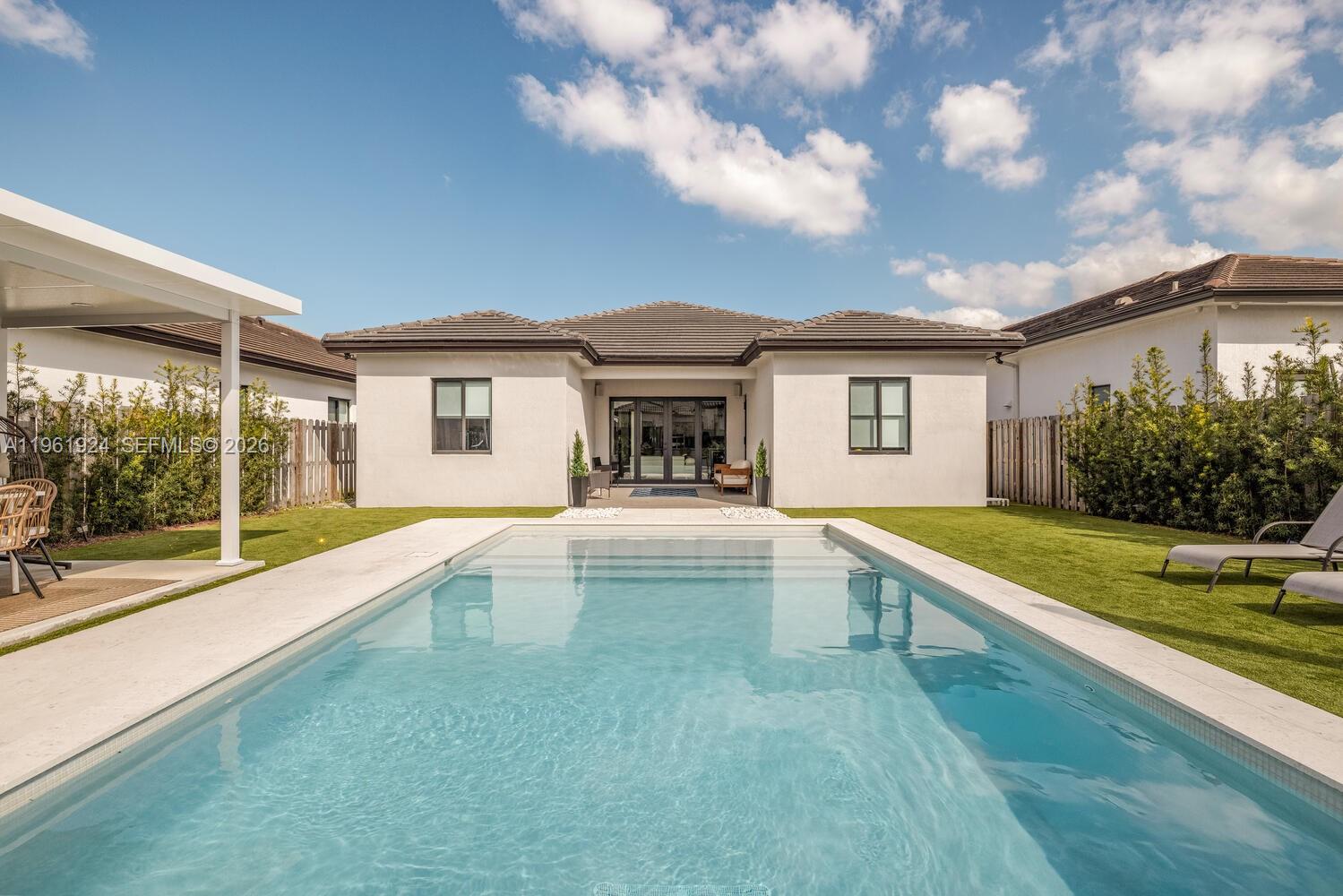 14468 Southwest 16th Street Miami, FL 33175 - Photo 3 of 46 a view of house with swimming pool and yard