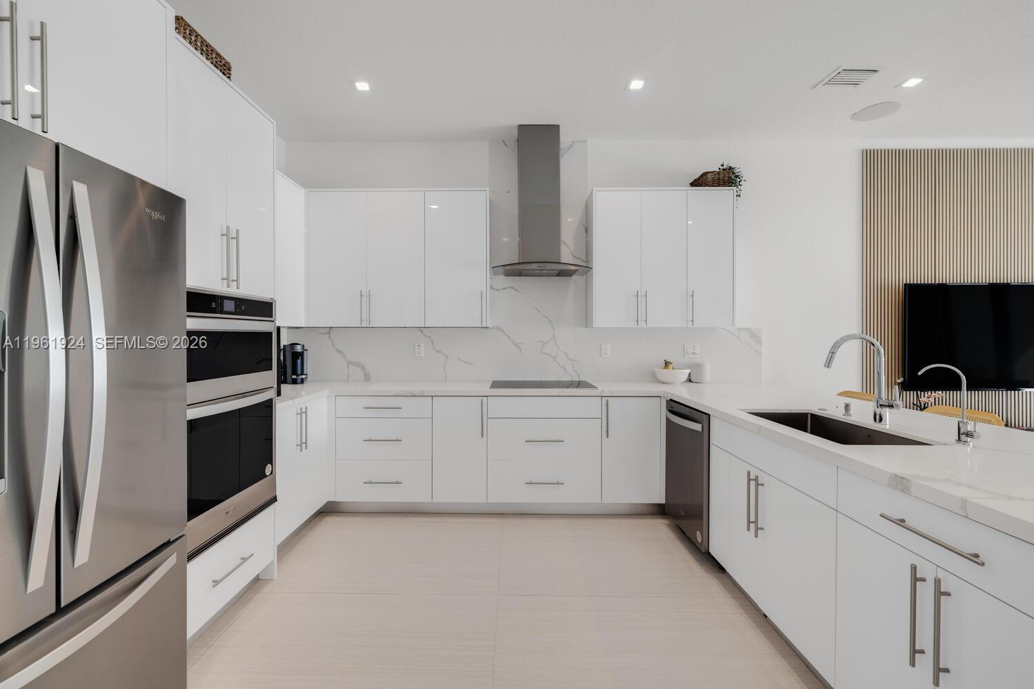 14468 Southwest 16th Street Miami, FL 33175 - Photo 32 of 46 a kitchen with white cabinets stainless steel appliances and sink