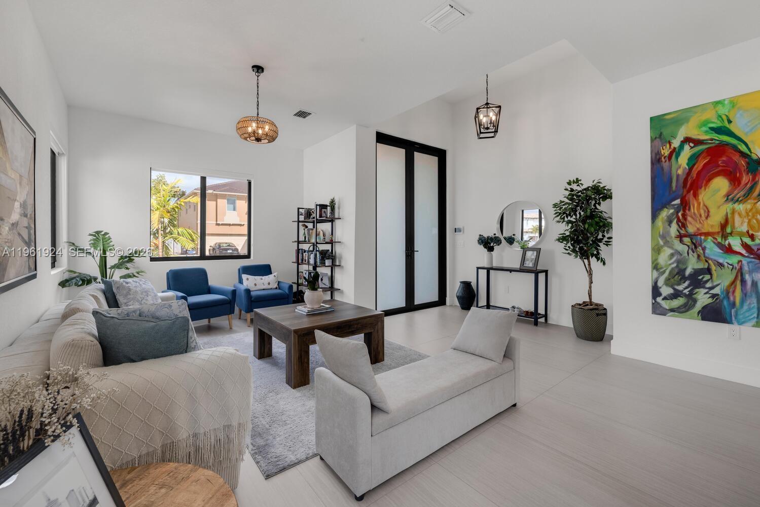 14468 Southwest 16th Street Miami, FL 33175 - Photo 33 of 46 a living room with furniture and a large window