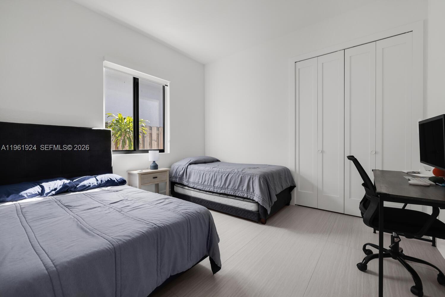 14468 Southwest 16th Street Miami, FL 33175 - Photo 34 of 46 a bedroom with a bed and a desk