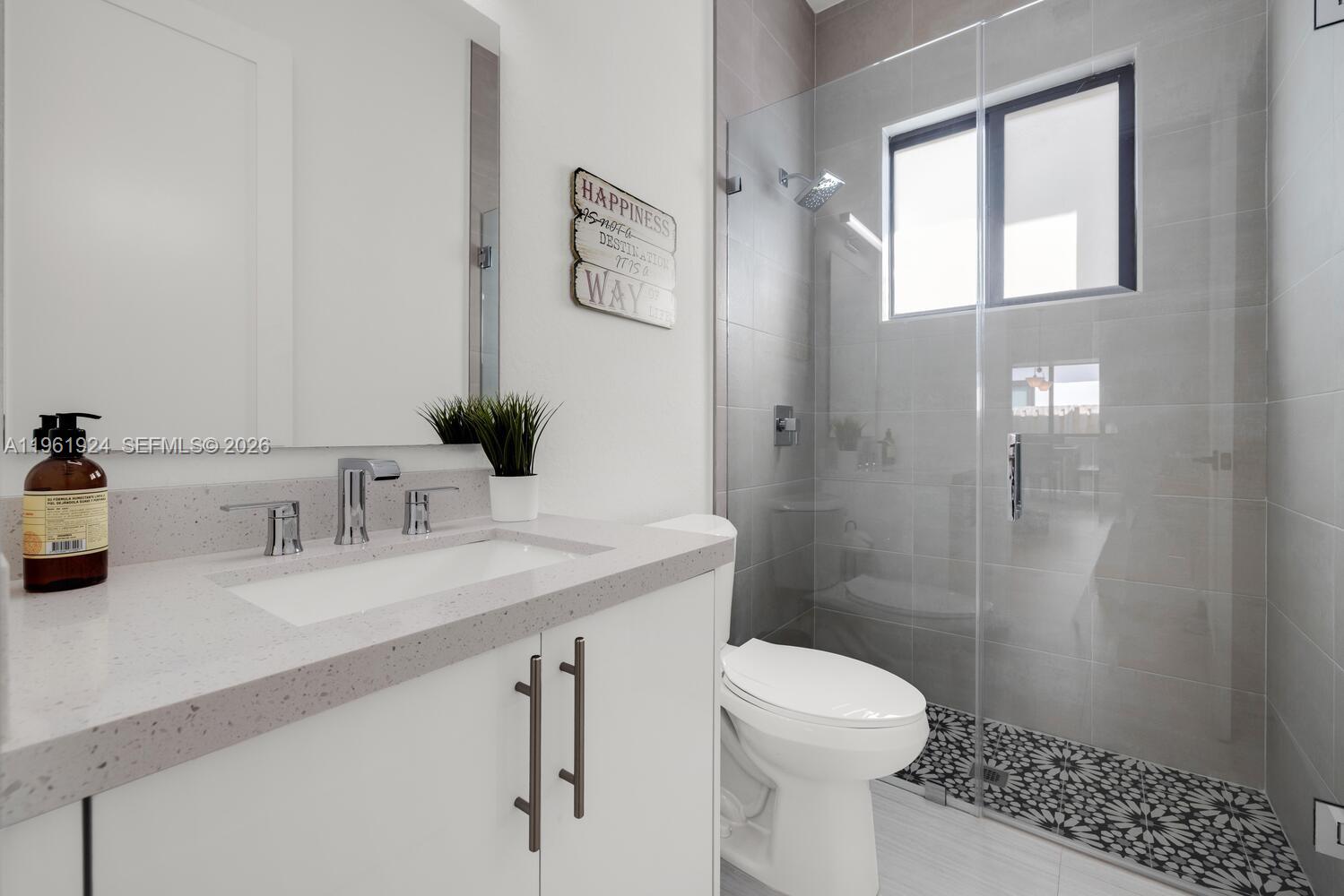 14468 Southwest 16th Street Miami, FL 33175 - Photo 35 of 46 a bathroom with a sink a toilet and shower