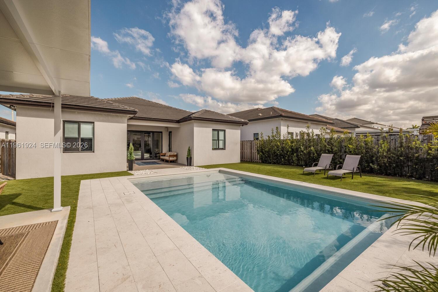 14468 Southwest 16th Street Miami, FL 33175 - Photo 39 of 46 a view of a house with swimming pool and sitting area