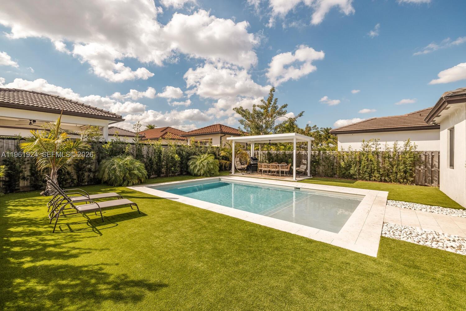 14468 Southwest 16th Street Miami, FL 33175 - Photo 40 of 46 a view of a swimming pool with a patio and a yard