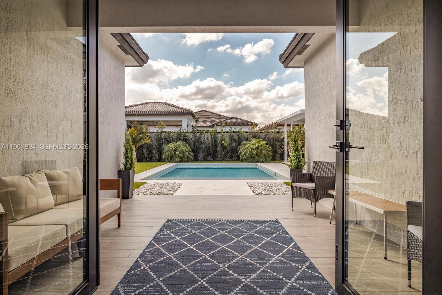 14468 Southwest 16th Street Miami, FL 33175 - Photo 42 of 46 a view of a porch with furniture and a yard