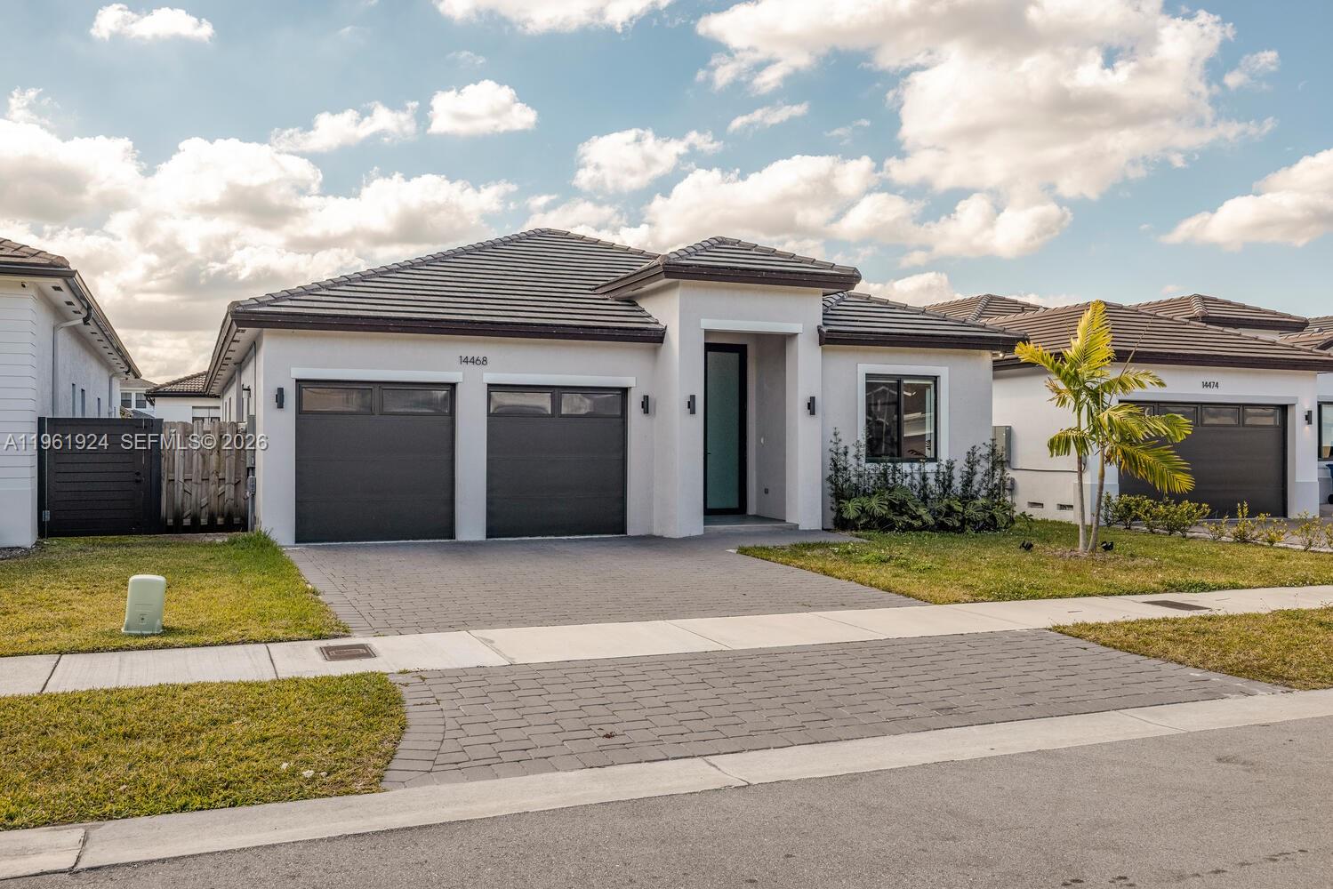 14468 Southwest 16th Street Miami, FL 33175 - Photo 44 of 46 a front view of a house with a yard and garage