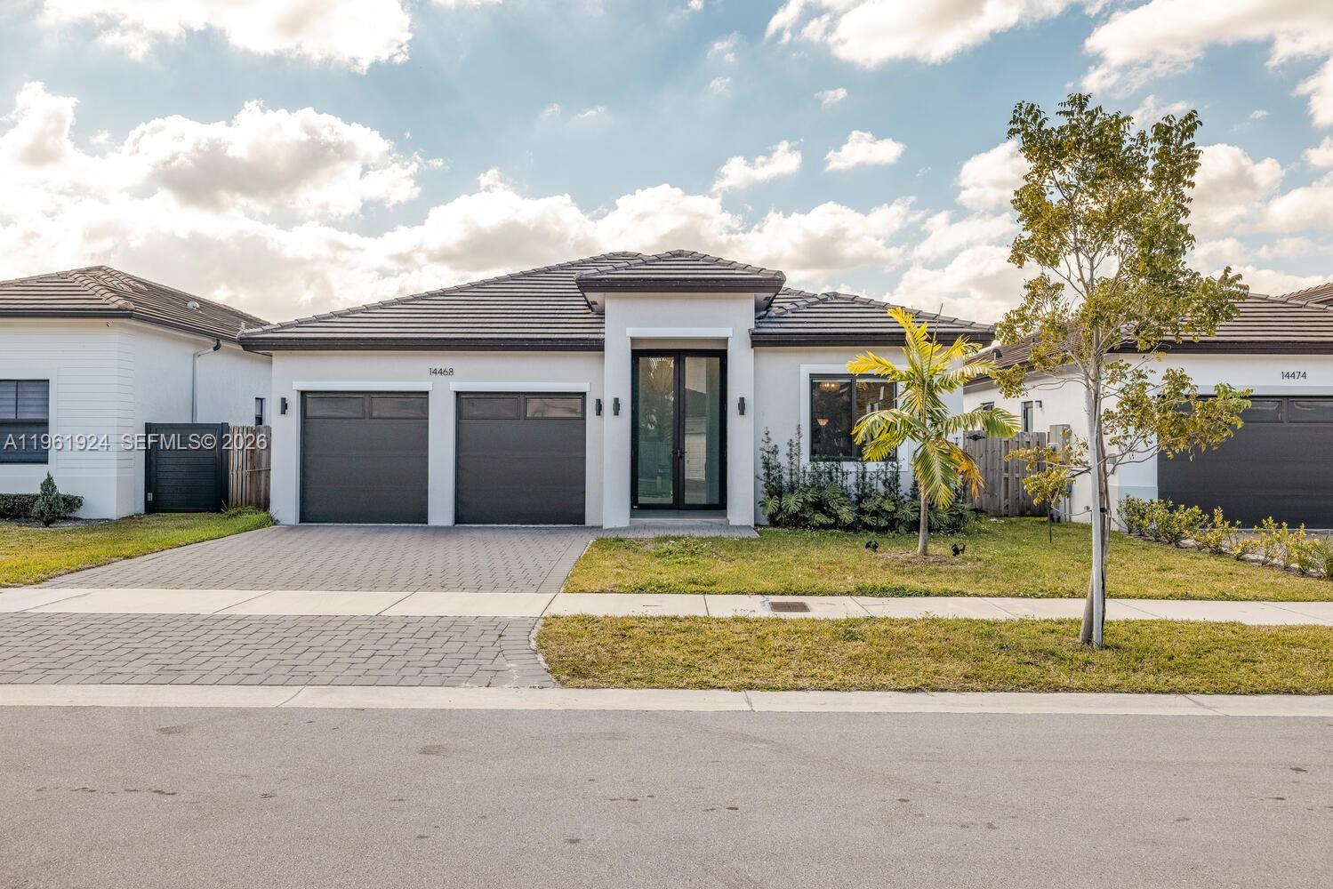 14468 Southwest 16th Street Miami, FL 33175 - Photo 46 of 46 a front view of a house with a yard and garage