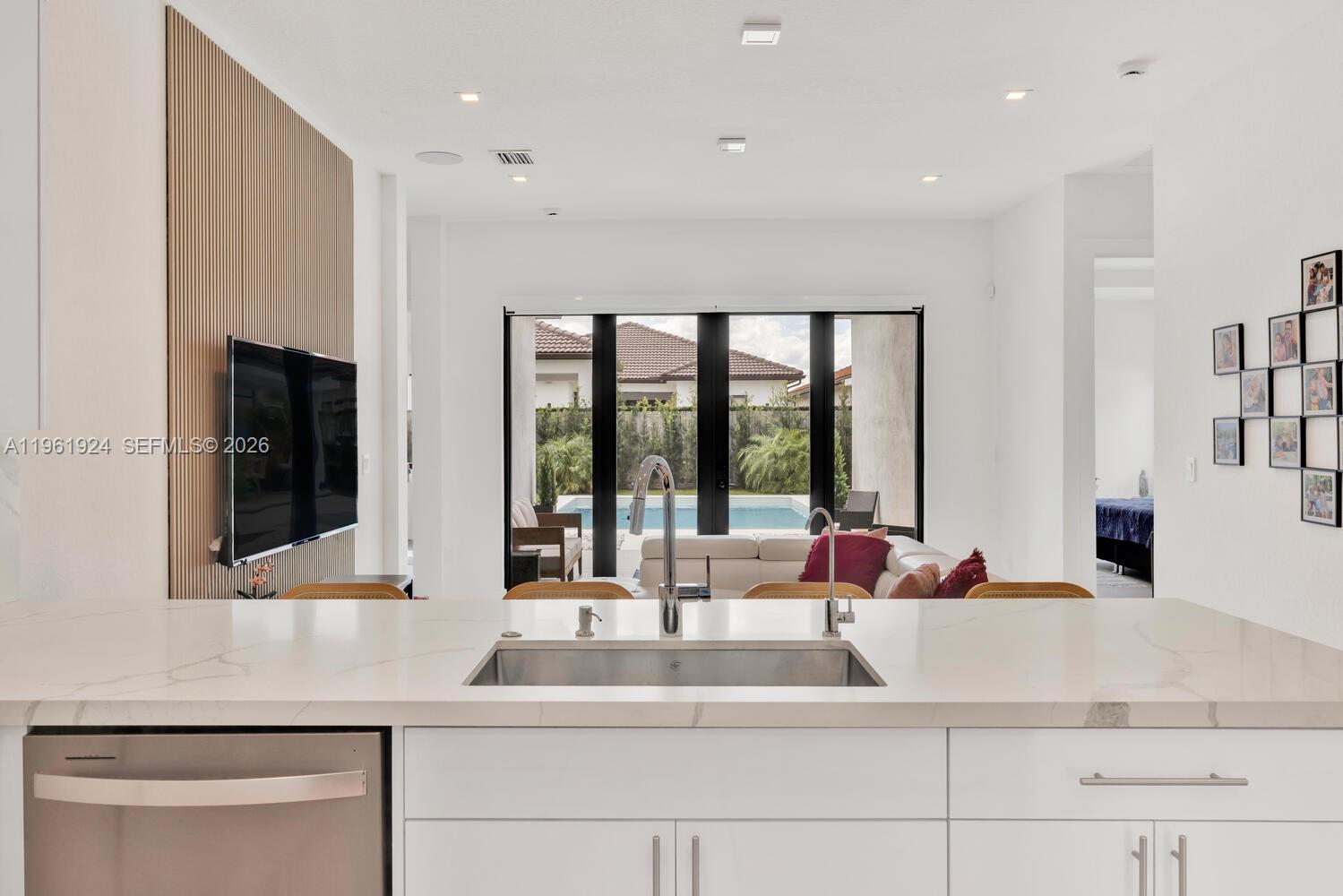 14468 Southwest 16th Street Miami, FL 33175 - Photo 9 of 46 a kitchen with kitchen island a sink and a large window