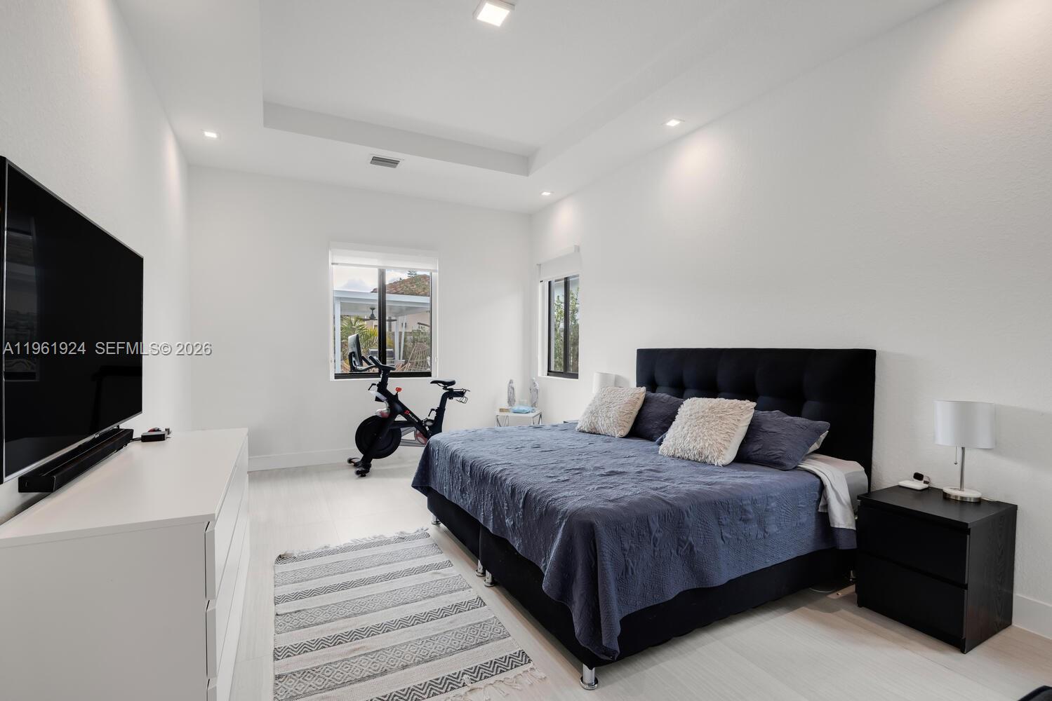 14468 Southwest 16th Street Miami, FL 33175 - Photo 10 of 46 a bedroom with a bed and a flat screen tv