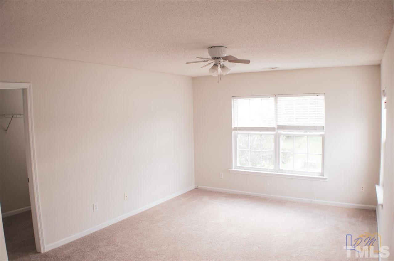 2636 Quarry Ridge Lane Raleigh, NC 27610 - Photo 8 of 12 an empty room with a window and a fan