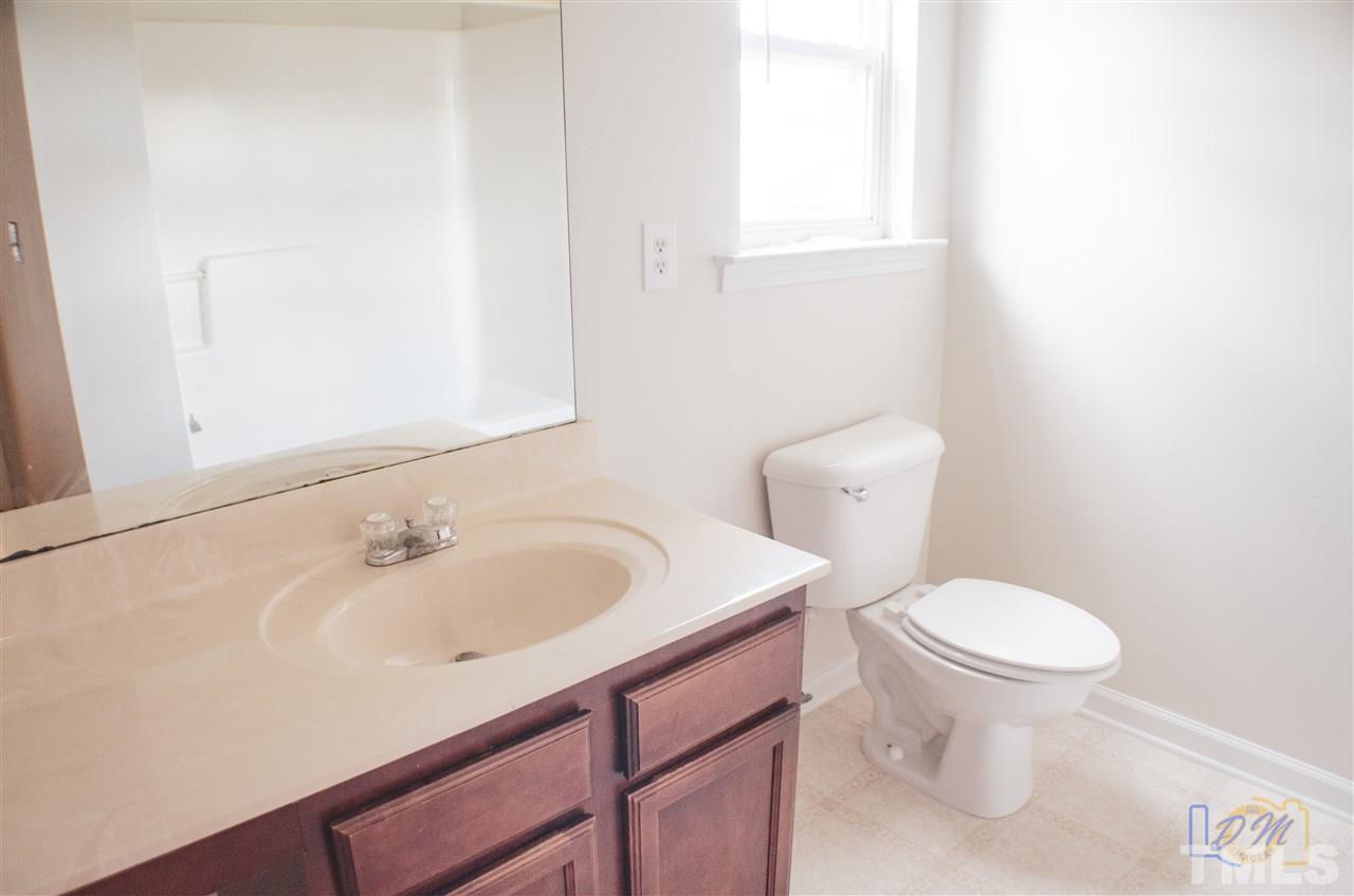 2636 Quarry Ridge Lane Raleigh, NC 27610 - Photo 9 of 12 a bathroom with a sink a toilet and a mirror