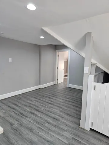 a view of hallway with wooden floor