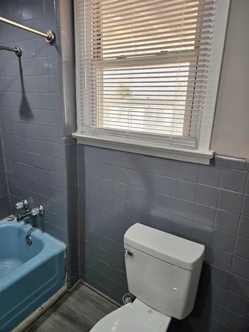 a bathroom with a toilet a sink and shower