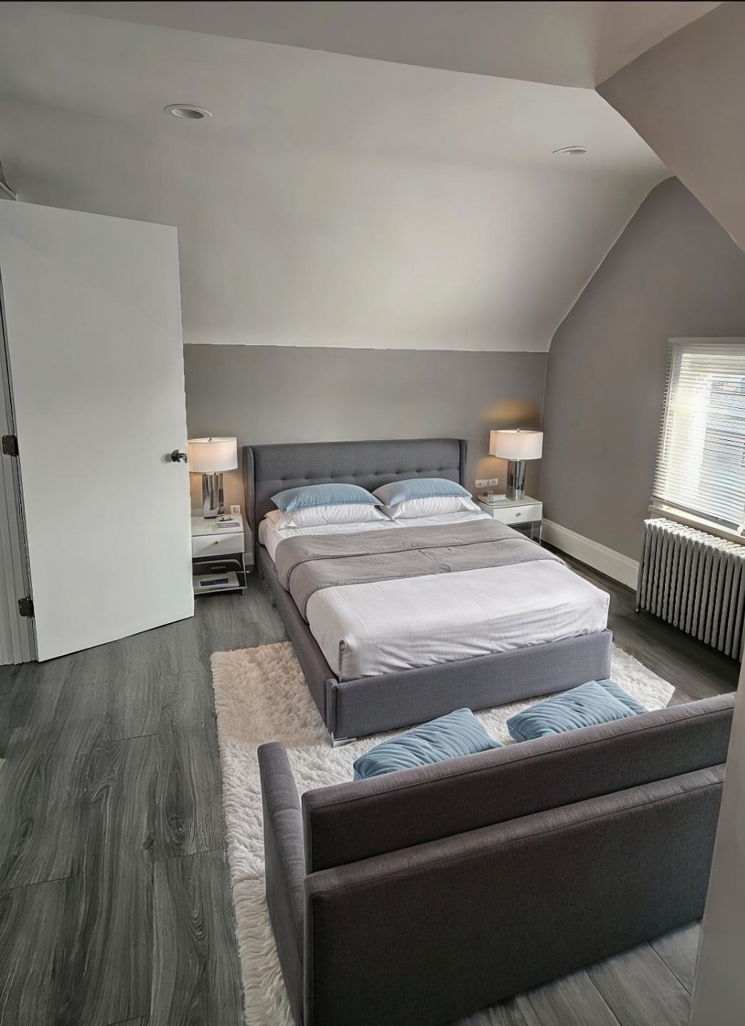 127-129 West 3rd Street, Unit 3 Bayonne, NJ 07002 - Photo 8 of 10 a bedroom with a bed and wooden floor