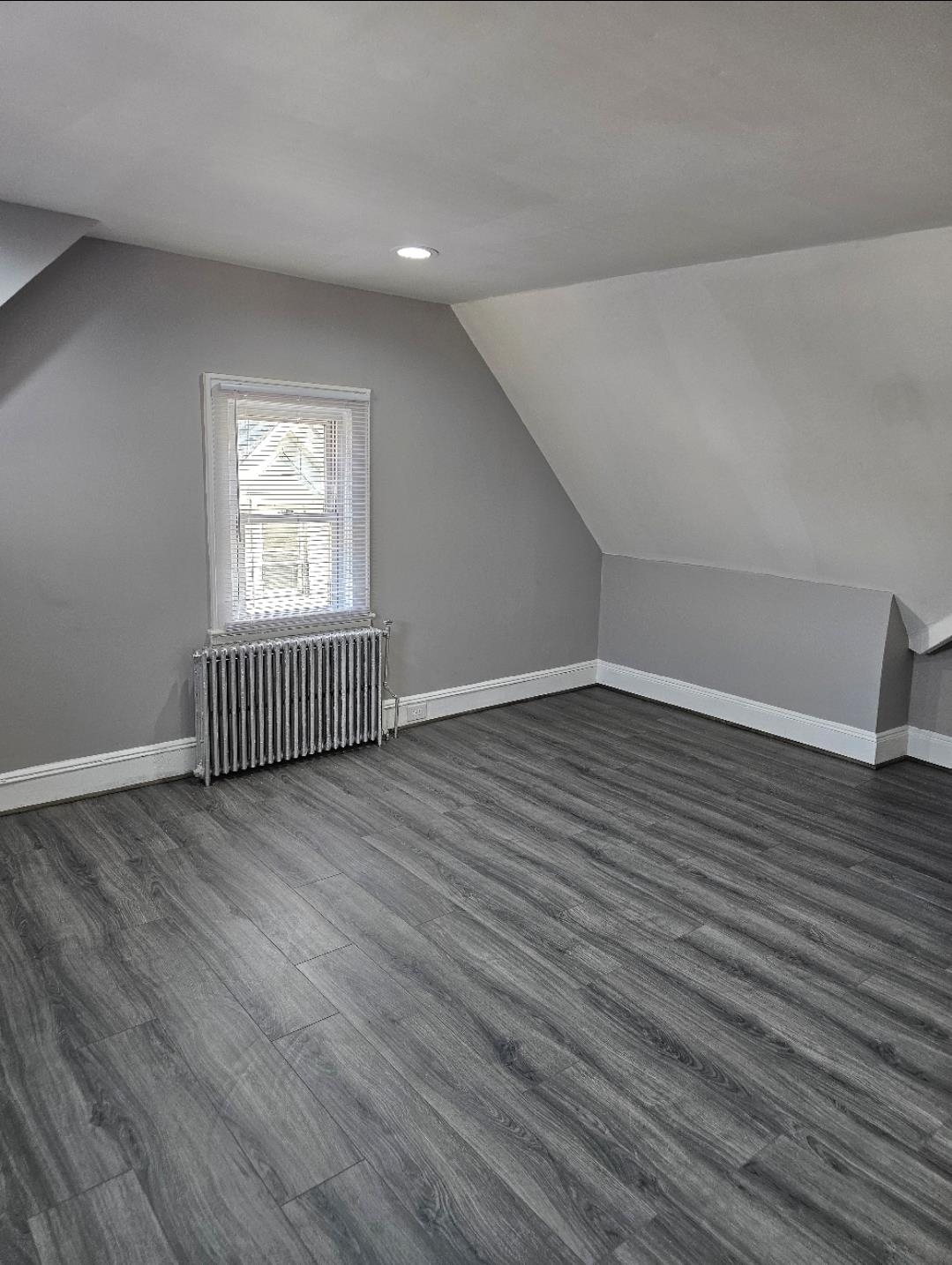 127-129 West 3rd Street, Unit 3 Bayonne, NJ 07002 - Photo 9 of 10 wooden floor in an empty room with a window