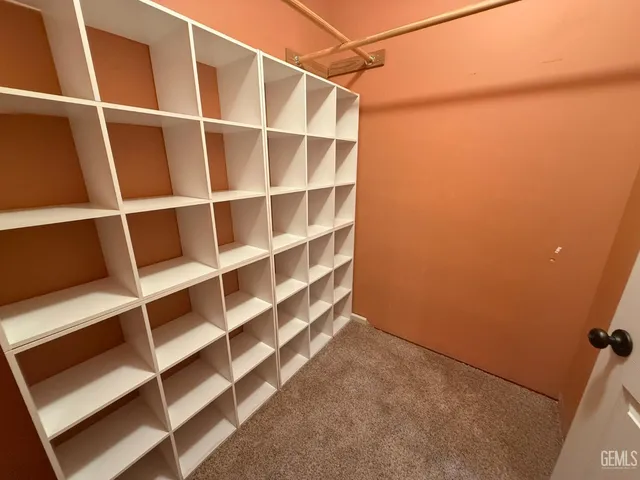a view of an empty room with empty shelves
