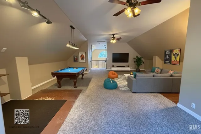 a room with pool table and flat screen tv