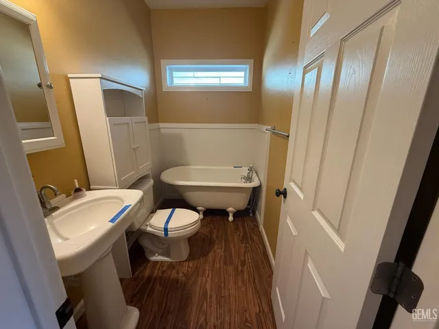 a bathroom with a sink a toilet a mirror and shower