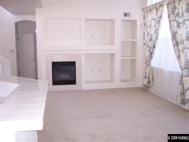 1267 Tule Drive Reno, NV 89521 - Photo 3 of 7 a view of empty room with fireplace