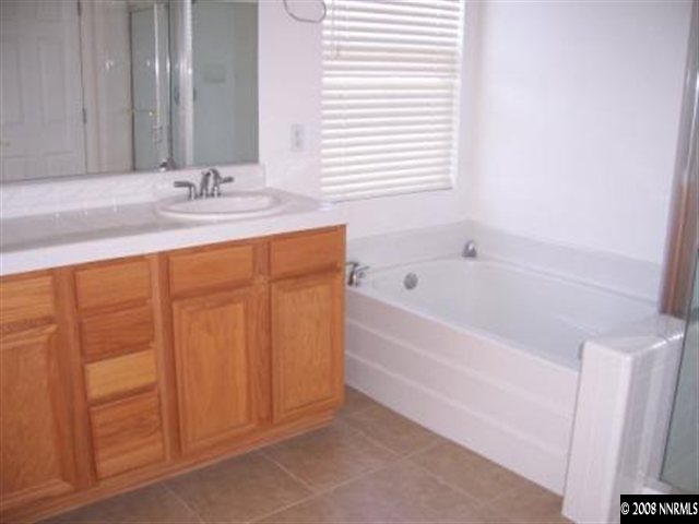 1267 Tule Drive Reno, NV 89521 - Photo 6 of 7 a bathroom with a bathtub and a sink