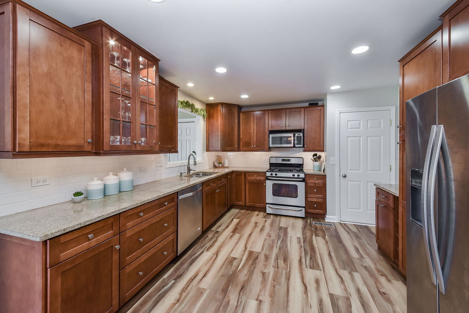 509 Turf Lane Wheaton, IL 60187 - Photo 4 of 16 a large kitchen with stainless steel appliances granite countertop a refrigerator and a stove top oven