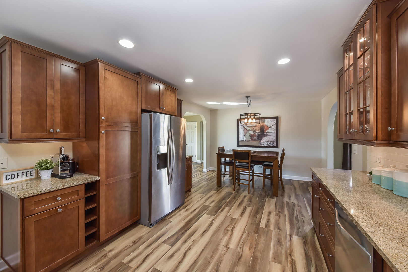 509 Turf Lane Wheaton, IL 60187 - Photo 5 of 16 a kitchen with stainless steel appliances granite countertop furniture wooden floor and a refrigerator