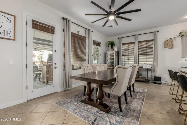 a dining hall with stainless steel appliances a dining table and chairs