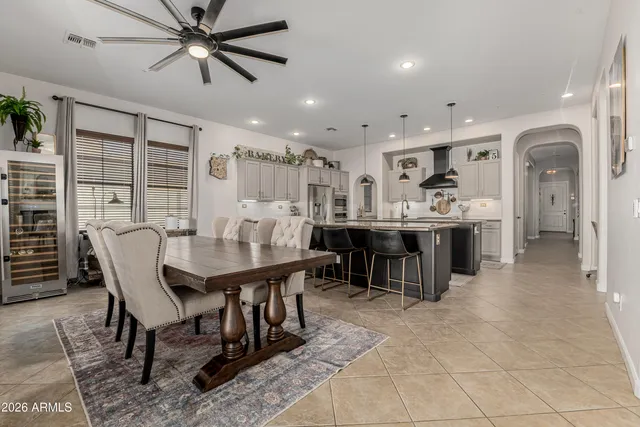 a kitchen with kitchen island granite countertop a table chairs stove and refrigerator