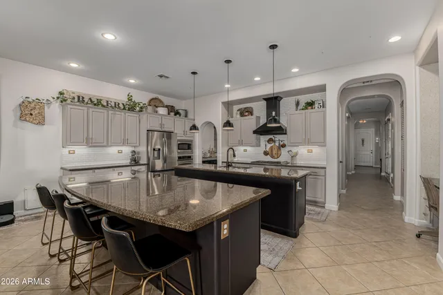 a kitchen with stainless steel appliances granite countertop a sink stove and cabinets