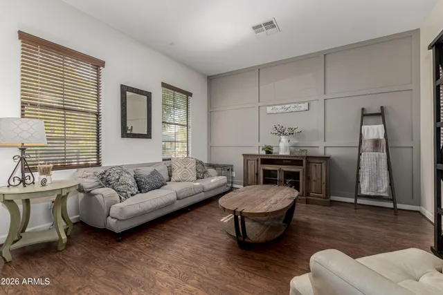 a spacious bedroom with a bed and wooden floor