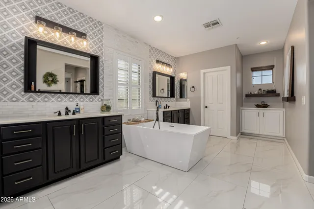 a bathroom with a double vanity sink and a mirror