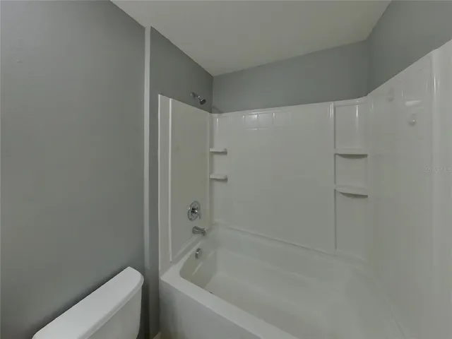 a bathroom with a bathtub and shower