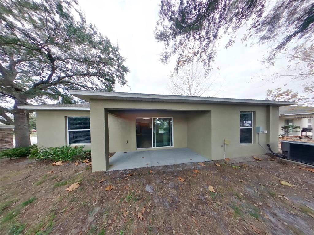 Undisclosed Address Spring Hill, FL 34609 - Photo 15 of 15 a front view of a house with a yard and garage