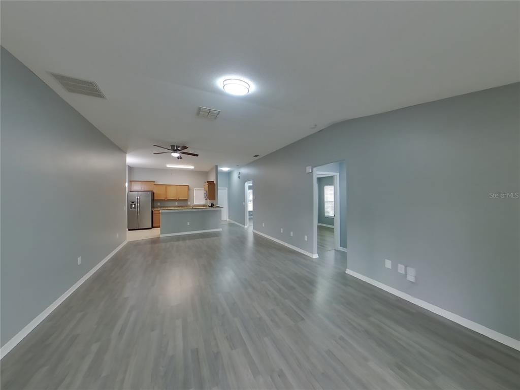 Undisclosed Address Spring Hill, FL 34609 - Photo 2 of 15 wooden floor in an empty room with a window