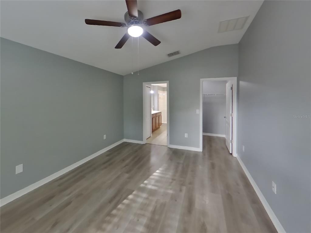 Undisclosed Address Spring Hill, FL 34609 - Photo 6 of 15 an empty room with closet and a ceiling fan