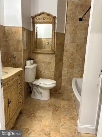 a bathroom with a toilet sink and shower