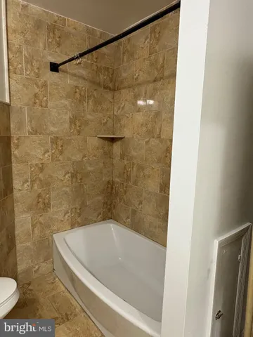 a bath tub sitting next to a toilet